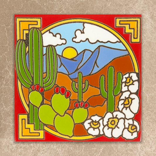 Decorative tile with desert scene featuring cacti, flowers, and mountains on a red background.