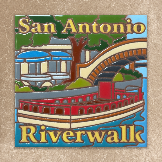 Decorative ceramic tile with 'San Antonio Riverwalk' text and a paddlewheel boat design on a beige background.