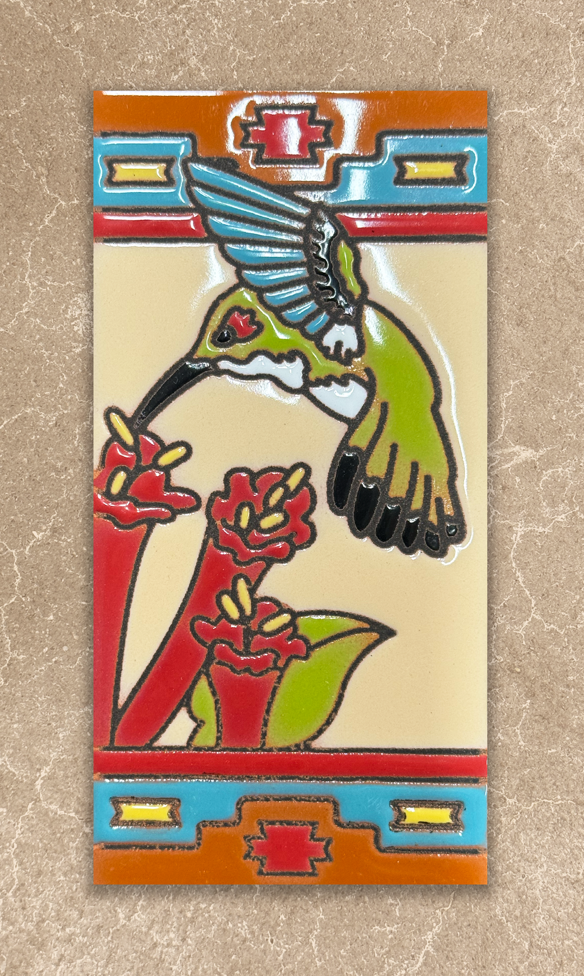 Decorative tile with a hummingbird and flowers on a beige background