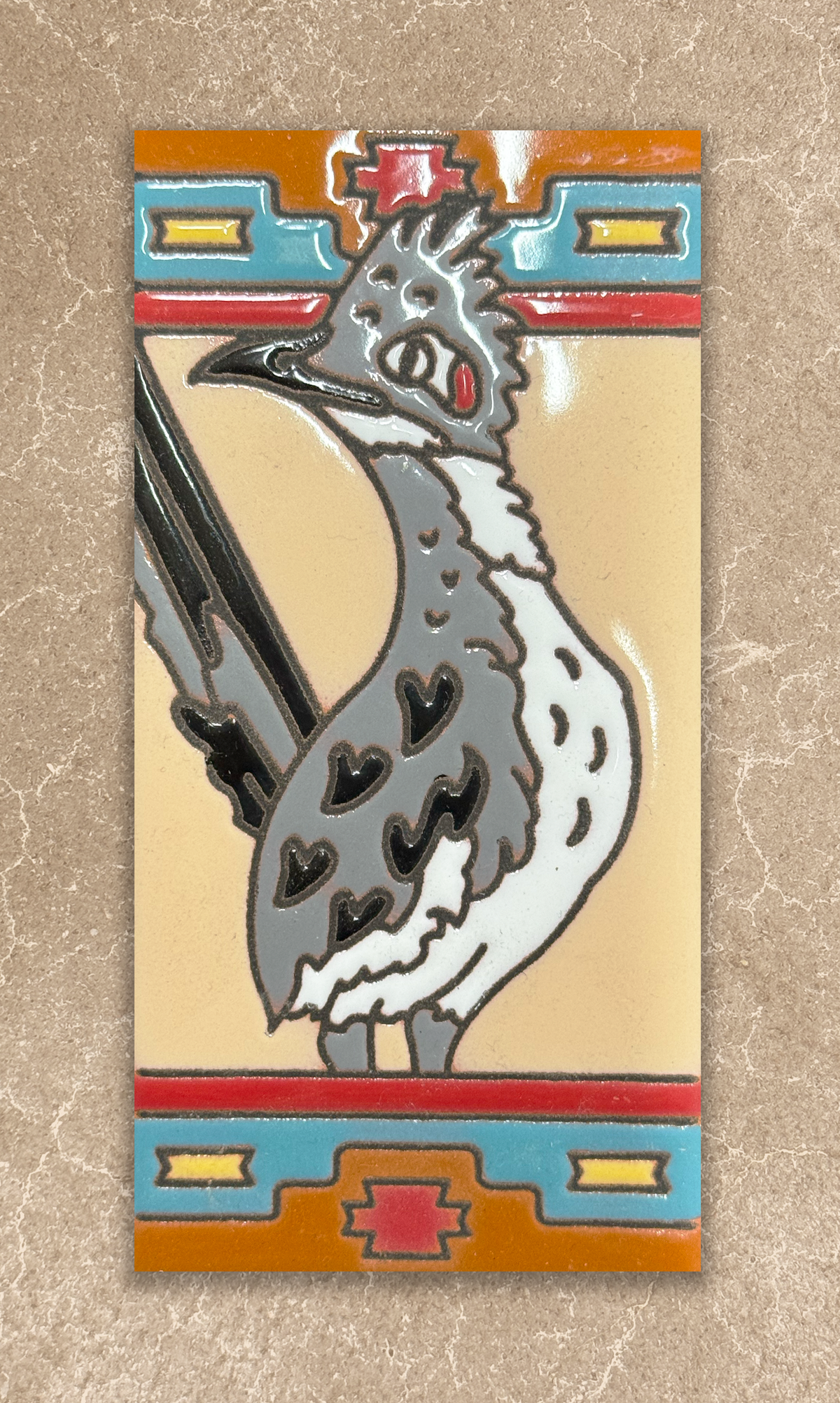 Decorative tile with a rooster design on a beige background