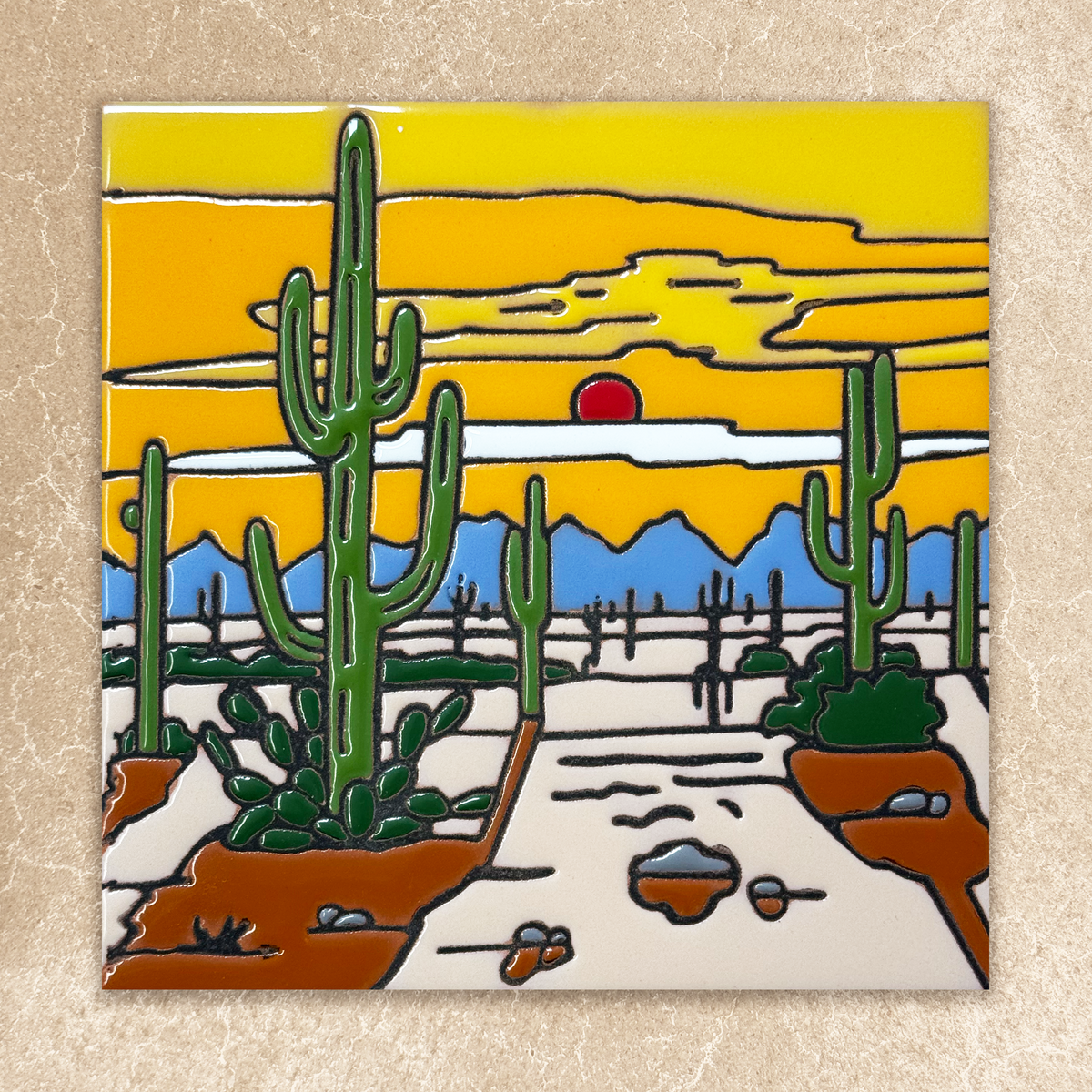 Desert scene with cacti and a sunset on a ceramic tile