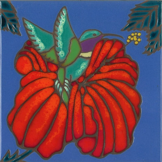 A square ceramic tile featuring a stylized, stained-glass-like design of a green hummingbird perched on a large red flower against a solid blue background.