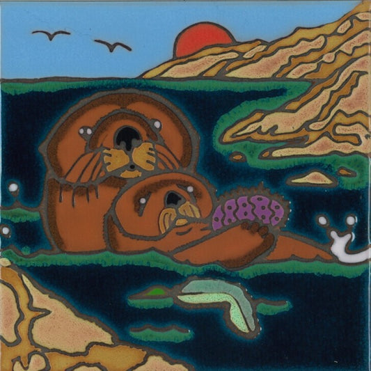 A square ceramic tile featuring a whimsical, folk-art style illustration of two brown sea otters in dark blue water, with a red sun, tan hills, and green shoreline.