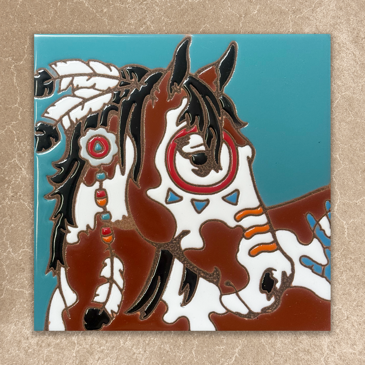Decorative tile with a horse design on a blue background