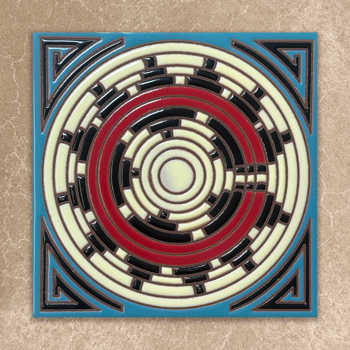 Decorative tile with concentric circle design on a beige background