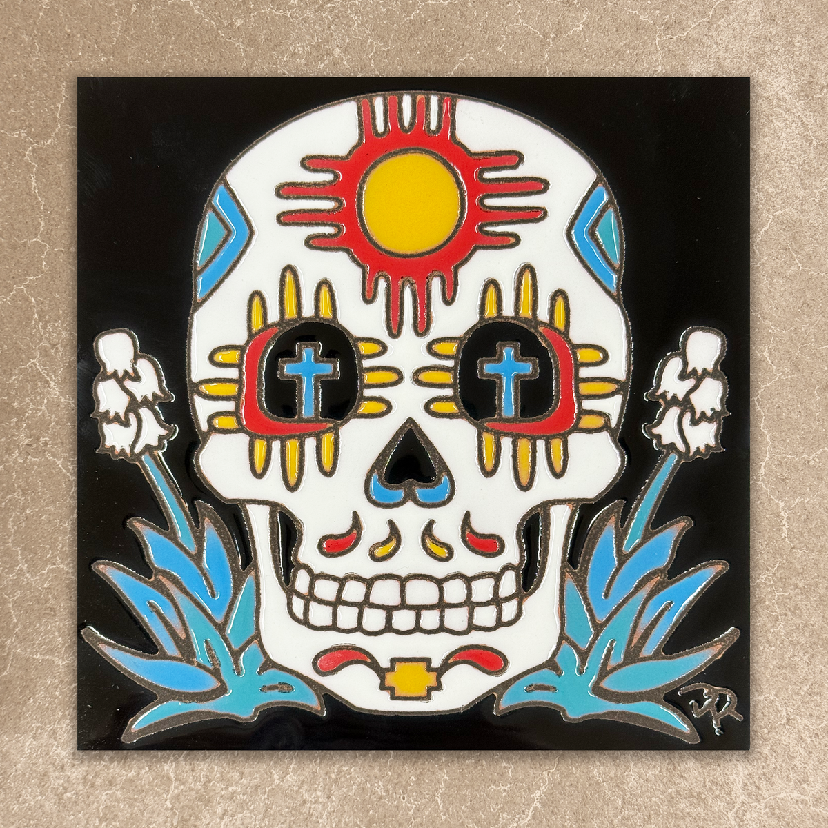 Colorful skull design with sun, zia, crosses, and flowers on a black border.
